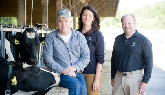 Farm Funders employees on site with a dairy farmer