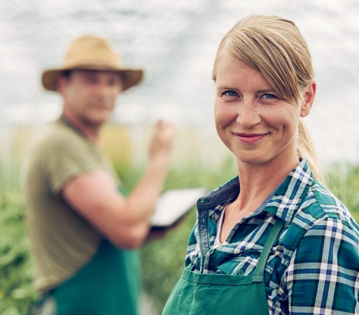 Greenhouse grower smiling