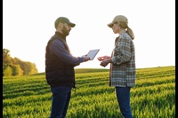Farmers in field with tablet